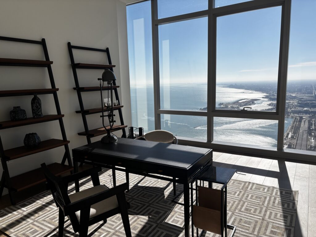 Tidy home office with desk and shelving overlooking the lake.